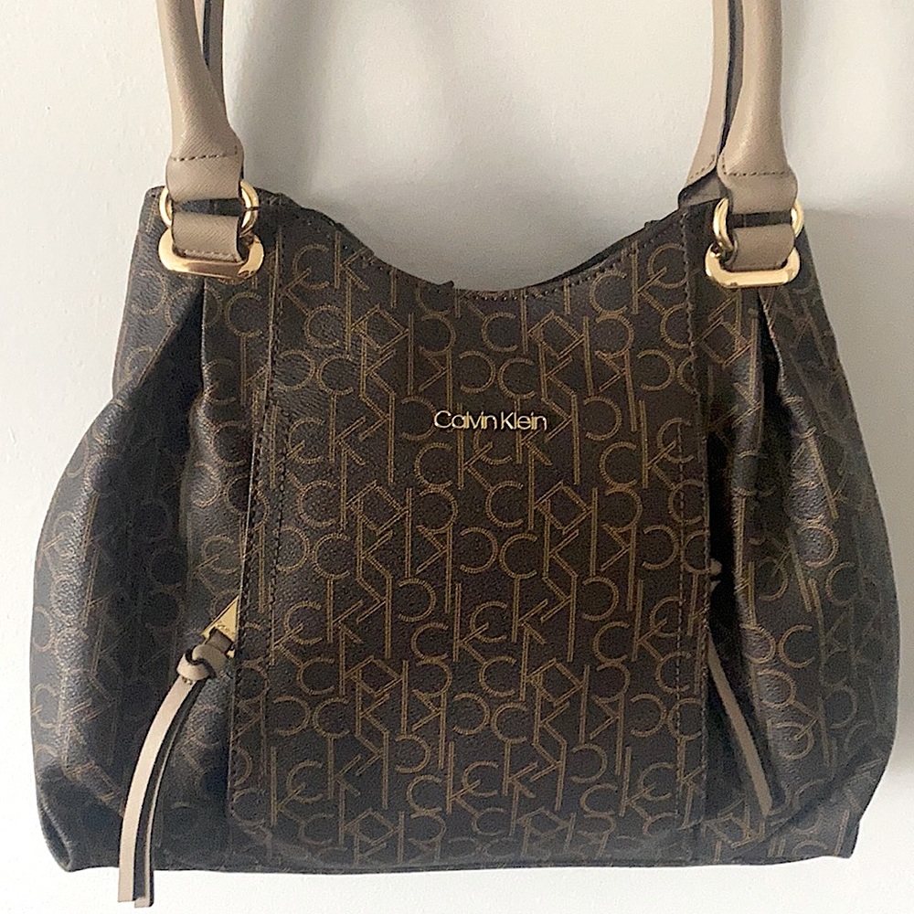 Brand new Calvin Klein tote. Classic, leather tote with many zipper compartments